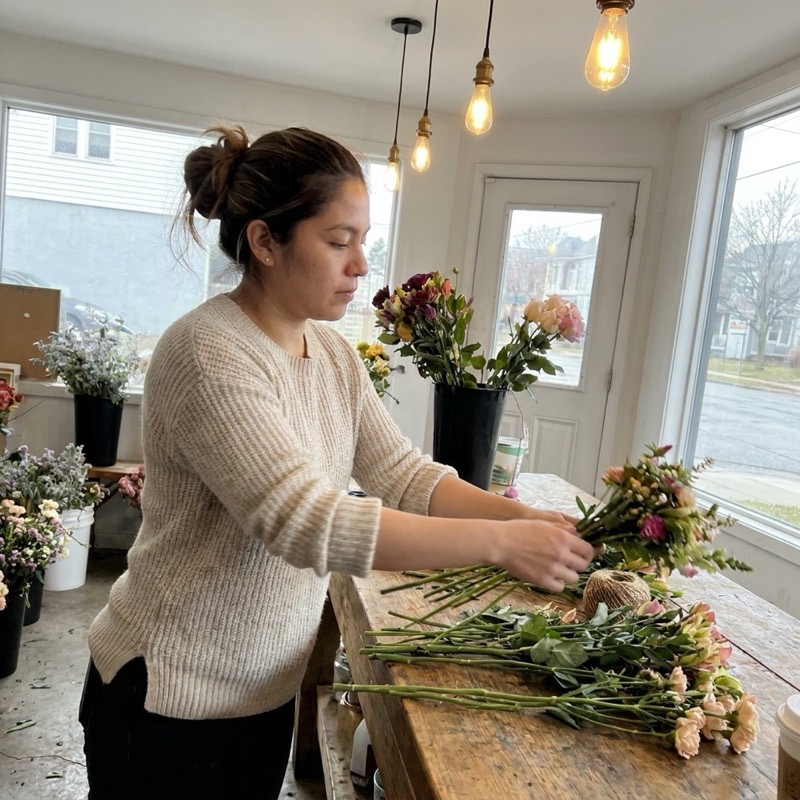 a florist arranging flowers in her shop